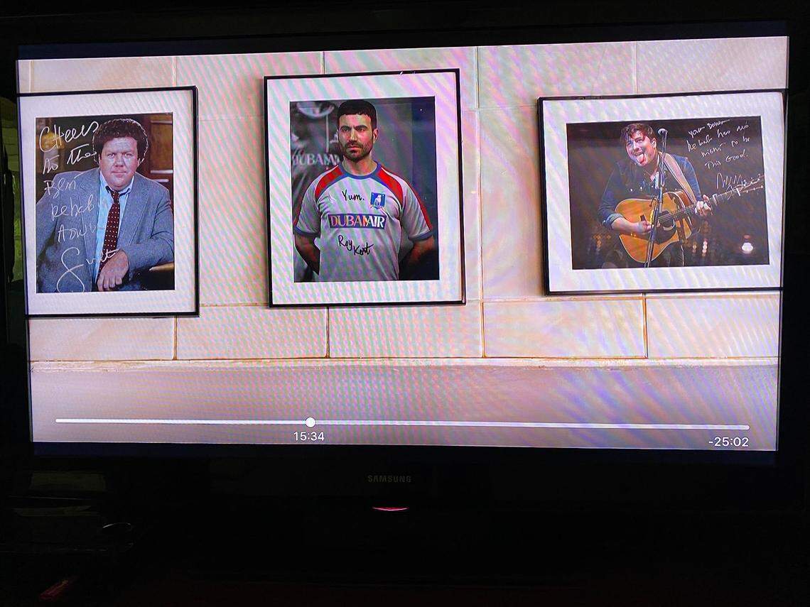The photos on the wall at the the kebab shop, from left: “Cheers” star George Wendt, AFC Richmond star Roy Kent (Brett Goldstein) and singer/songwriter Marcus Mumford.