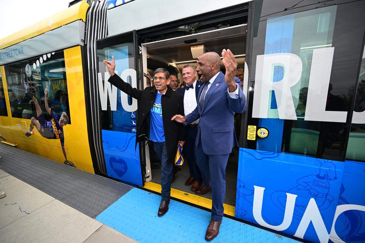 UMKC Chancellor C. Mauli Agrawal, left, Tom Gerend, executive director for KC Streetcar Authority, center, and Kansas City Mayor Quinton Lucas step off a streetcar after riding during an inaugural run on Friday, Oct. 24, 2025, during the grand opening celebration for the KC Streetcar extension in Kansas City.