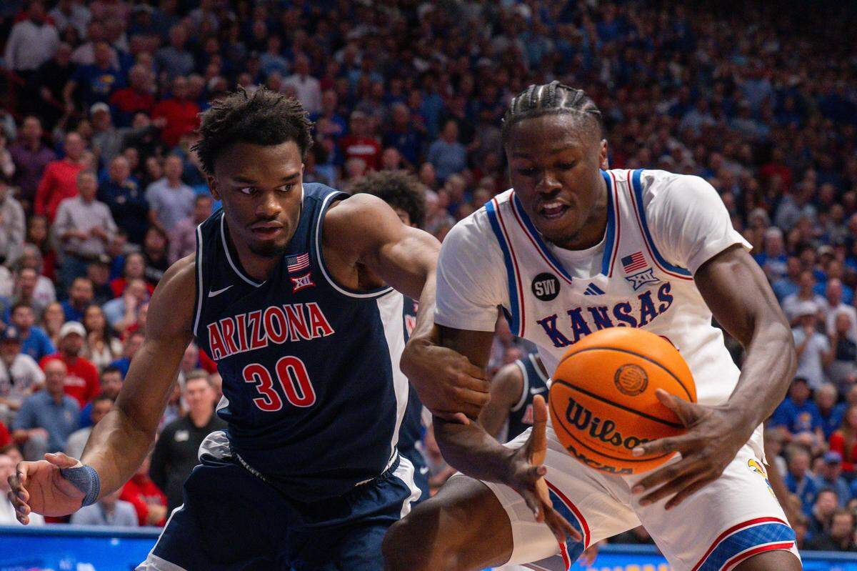 Kansas Jayhawks forward Flory Bidunga (40) fights for a loose ball with Arizona Wildcats forward Tobe Awaka (30) in the first half on Monday, February 9, 2026, at Allen Fieldhouse.