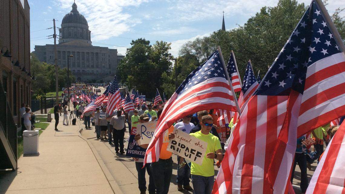 Opponents of right to work marched to the Missouri secretary of state's office to drop off 310,000 petitions seeking a vote to repeal the law in 2018.