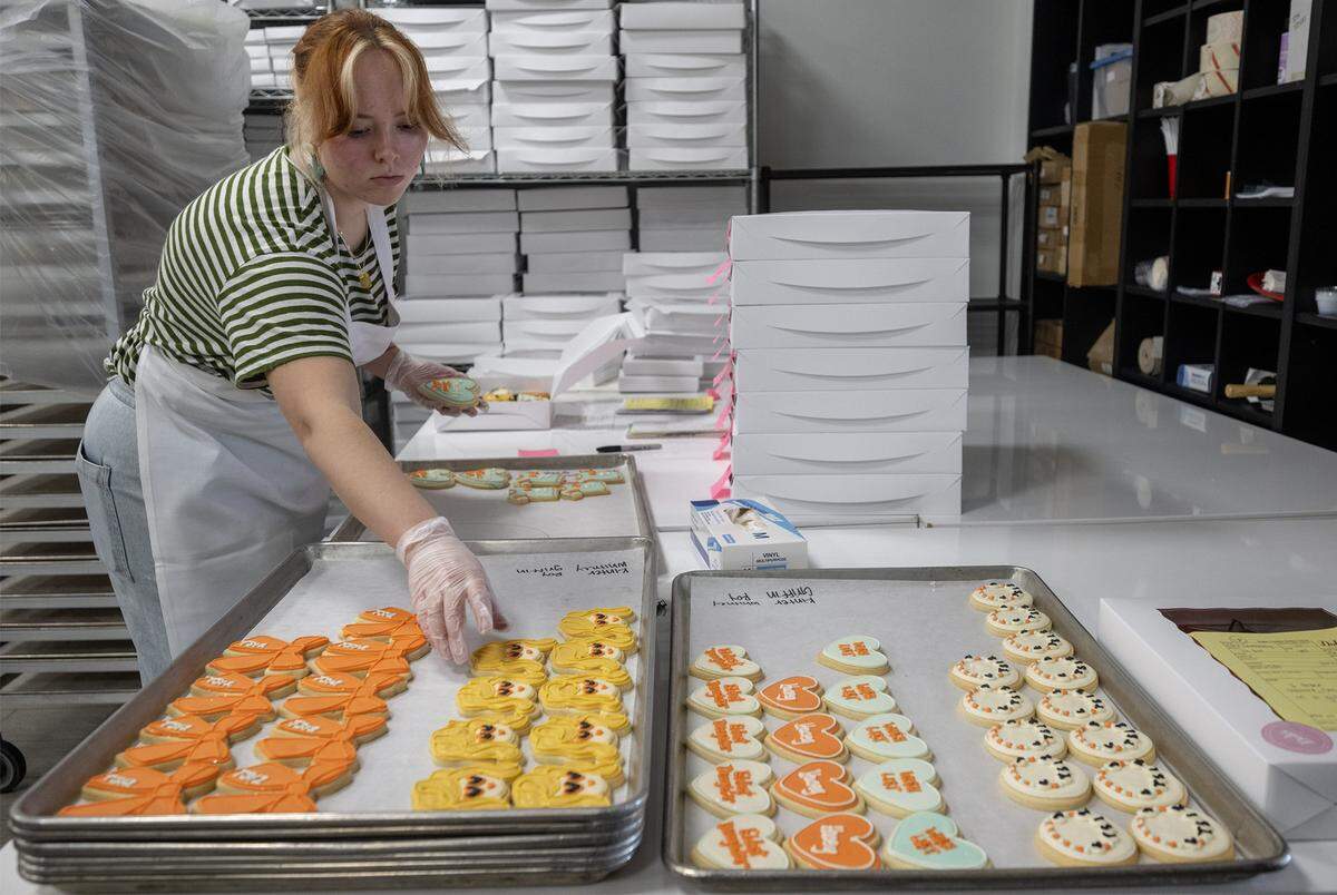Campbell Brown handmade, Taylor Swift-themed sugar cookies for an order at Dolce Bakery in Prairie Village on Thursday, October 2, 2025. Kansas City-area bakeries are seeing a significant demand for pop-icon-themed baked goods, with local fans celebrating the latest moves of Taylor Swift and Chappell Roan.
