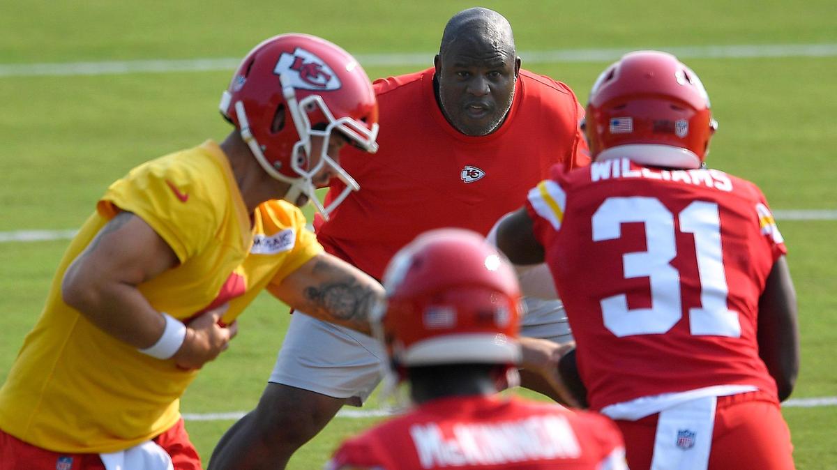 Kansas City Chiefs offensive coordinator, Eric Bieniemy, middle, watches running back Darrel Williams take a handoff during practice drills Monday morning at training camp in St. Joseph.