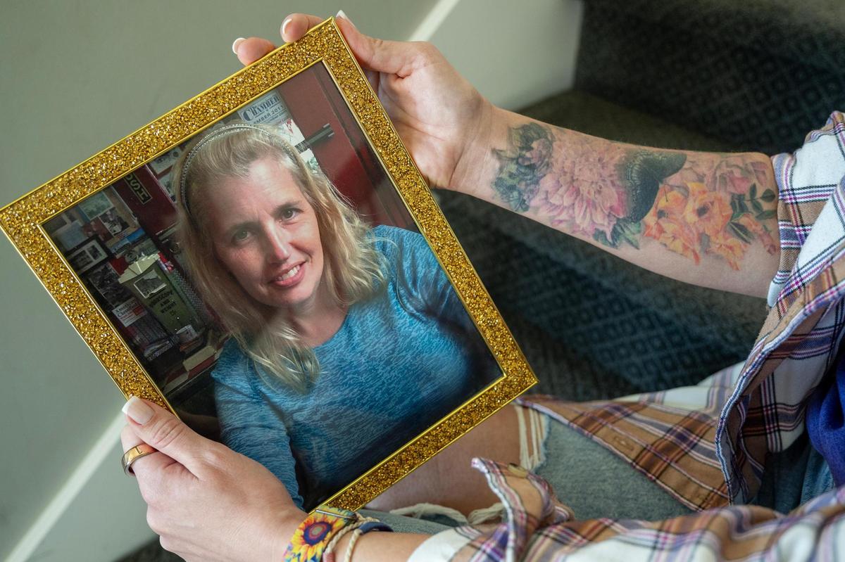 April Shaver holds a photograph of her mother Gwen Starkey, who died after a battle with Covid-19. Two weeks before her mother’s death, Shaver of Kansas City, got a tattoo—a butterfly and colorful gladiolas and dahlias, flowers her mother grew and loved, on her arm. “ I just wanted to make sure that she got to see my tribute to her,” said Shaver. “And every time I look at it, it makes me happy. Reminds me of her.”