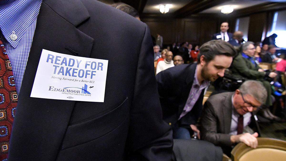 Supporters of KCI airport developer Edgemoor wore stickers showing their preference for the developer at a February meeting.