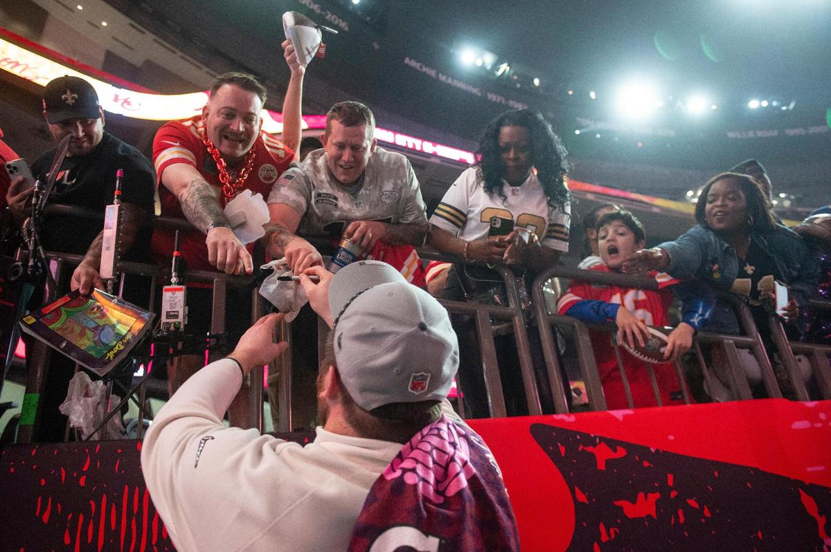 Kansas City Chiefs players sign autographs during opening night of the Super Bowl at Caesars Superdome in New Orleans on Monday, Feb. 3, 2025.