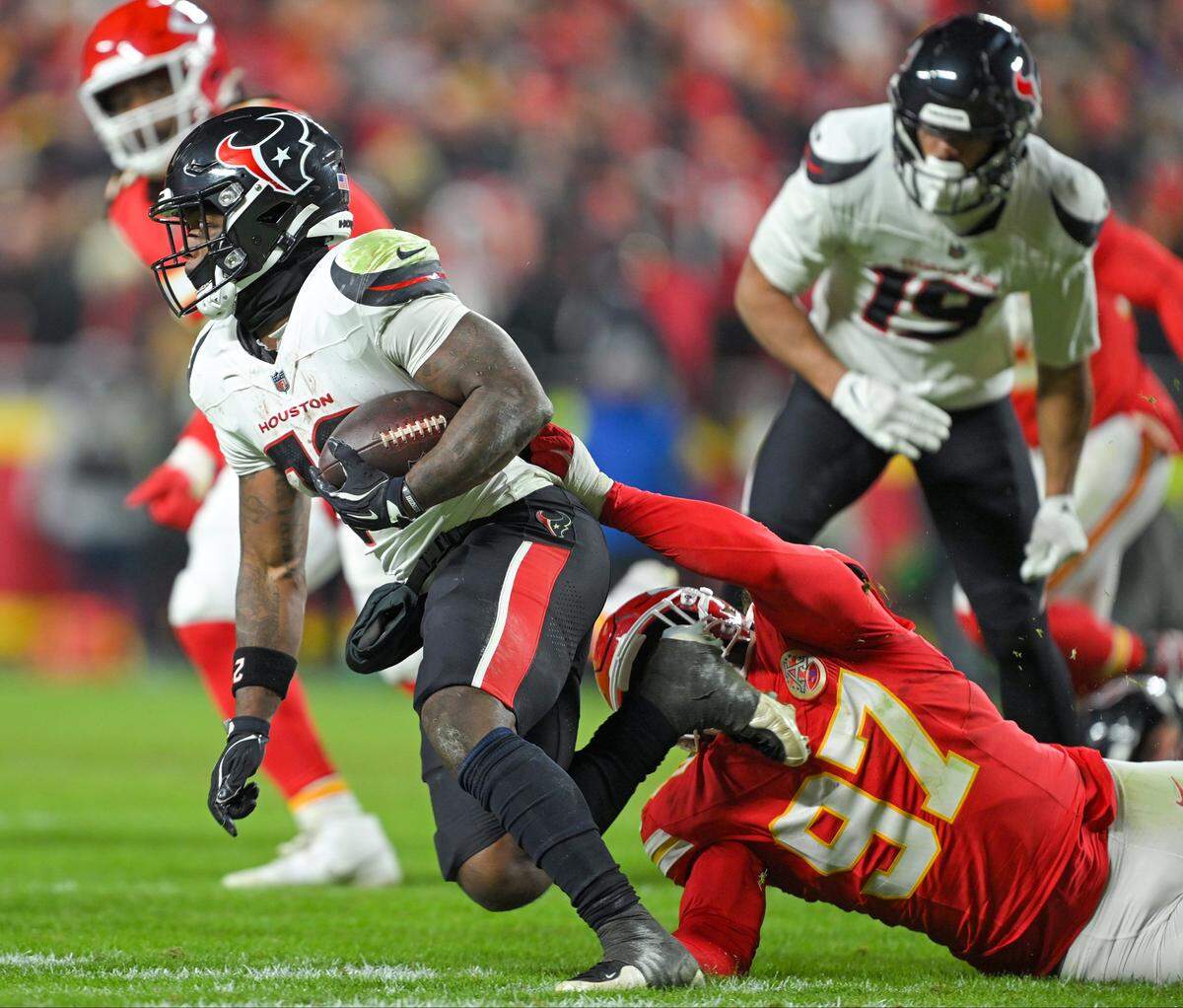 Kansas City Chiefs defensive end Ashton Gillotte (97) makes a tackle against the Houston Texans at GEHA Field at Arrowhead Stadium on Sunday, Dec. 7, 2025, in Kansas City.