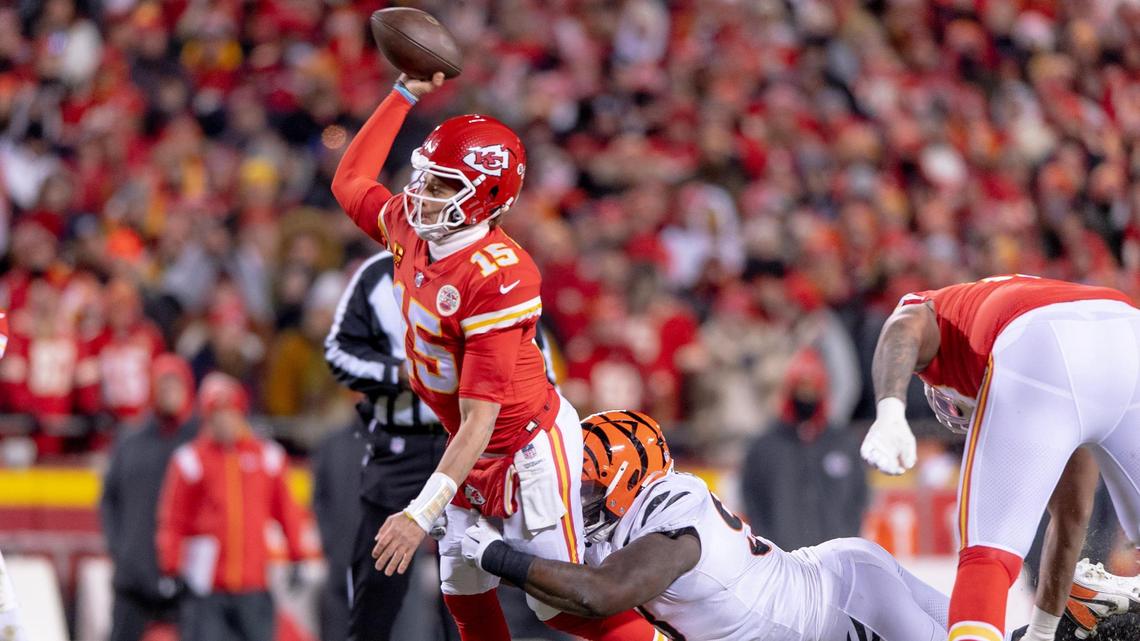 Kansas City Chiefs quarterback Patrick Mahomes (15) throws a pass as Cincinnati Bengals defensive tackle DJ Reader (98) tries to bring him down during the AFC Championship NFL football game at GEHA Field at Arrowhead Stadium on Sunday, Jan. 29, 2023, in Kansas City.