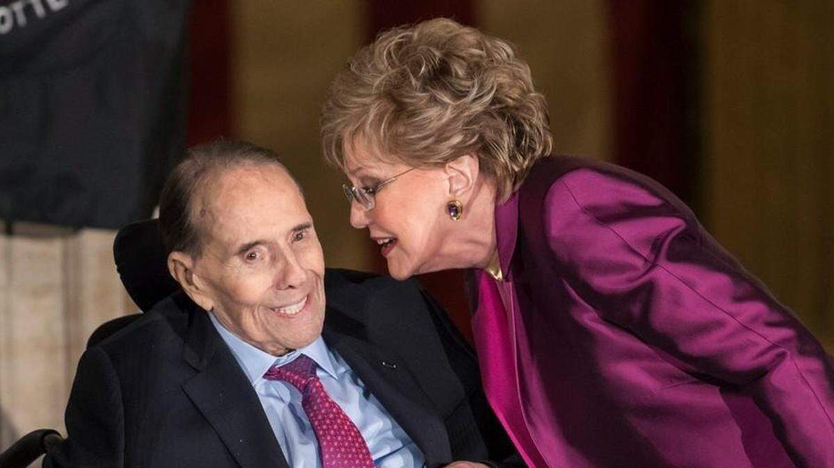Former Senate Majority Leader Bob Dole smiled as he got a kiss from his wife Elizabeth Dole as he was honored at the Capitol with a Congressional Gold Medal on Jan. 17, 2018.