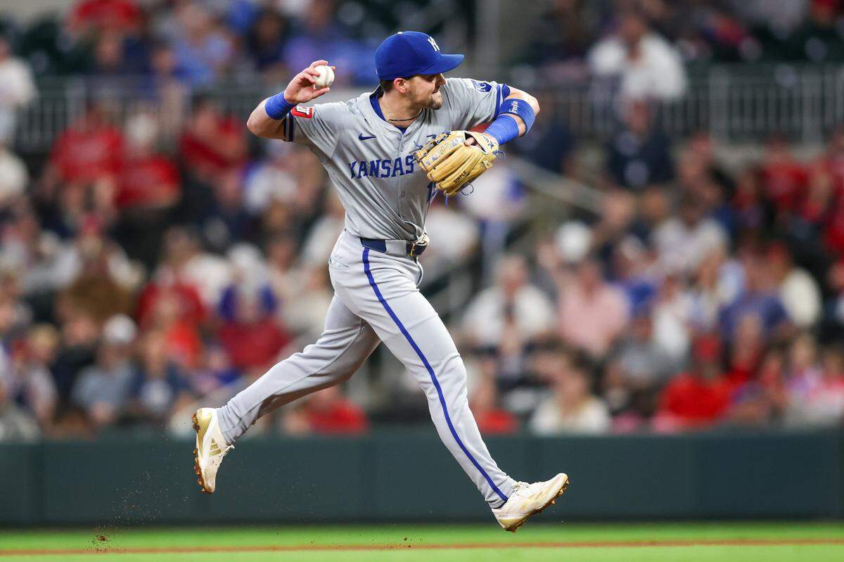 Kansas City Royals second baseman Michael Massey throws out a Braves runner at first during Friday evening’s game at Truist Park in suburban Atlanta.