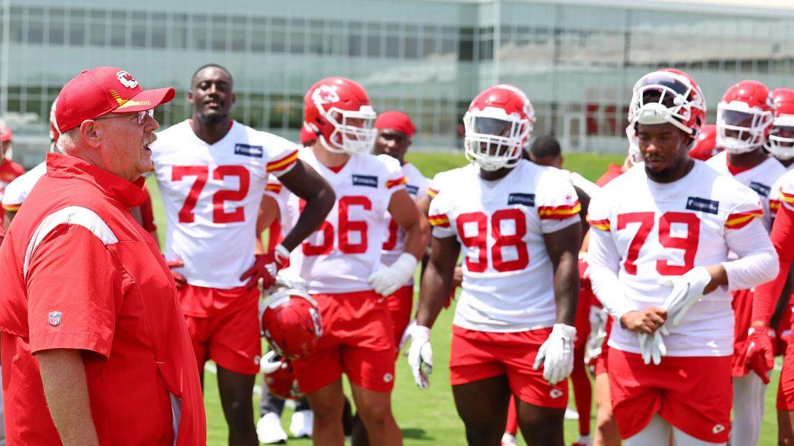 Kansas City Chiefs defensive tackle Kehinde Hassan Oginni, 72, along with other teammates listen to head coach Andy Reid during a mini-camp practice.
