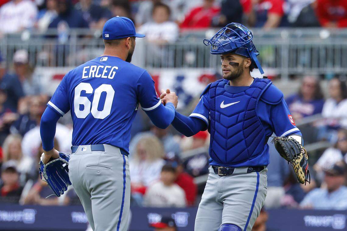 Lucas Erceg #60 and Carter Jensen #22 of the Kansas City Royals react following the Royals 4-1 victory over the Atlanta Braves at Truist Park on March 29, 2026 in Atlanta, Georgia.