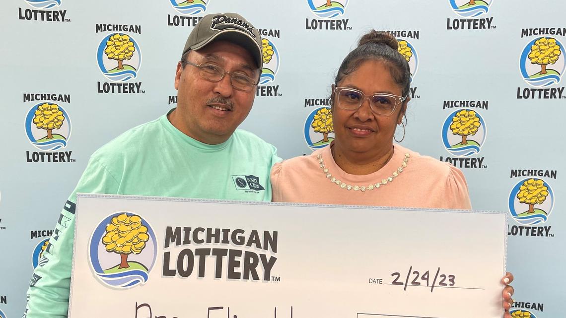 A husband and wife with their $1 million check.
