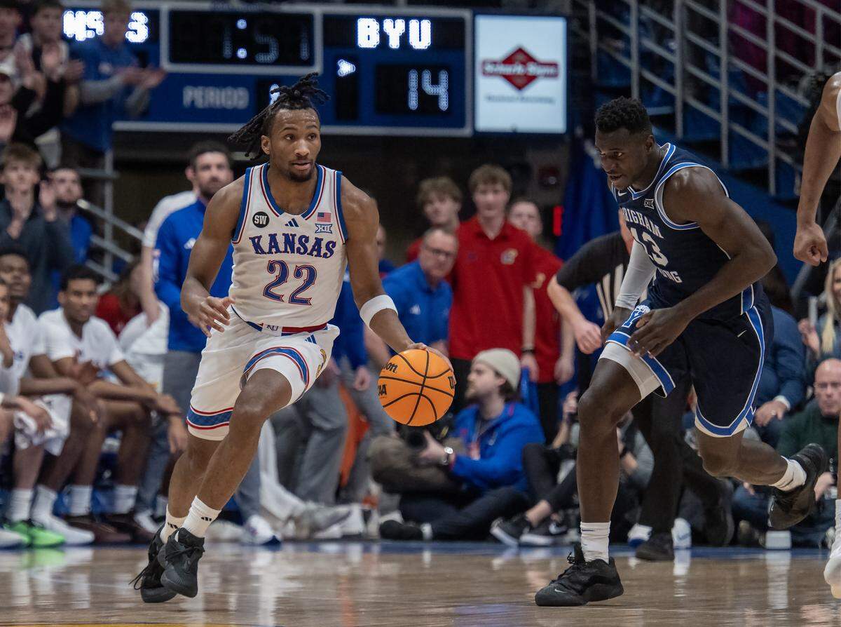 Kansas Jayhawks guard Darryn Peterson (22) dribbles past BYU Cougars center Keba Keita (13) in the first half at Allen Fieldhouse on Saturday, Jan. 31, 2026, in Lawrence.
