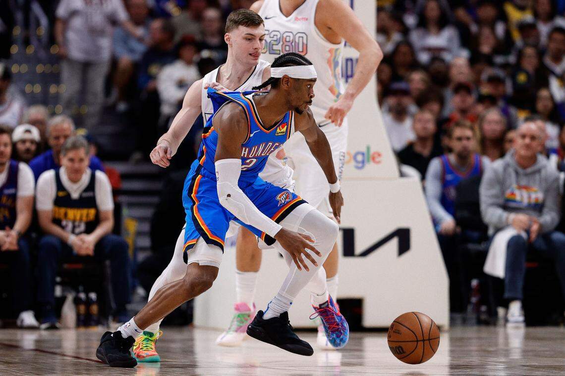 Oklahoma City Thunder guard Shai Gilgeous-Alexander (2) controls the ball as Denver Nuggets guard Christian Braun (0) guards in the third quarter during Game 6 of the second round for the 2025 NBA Playoffs at Ball Arena on May 15, 2025.