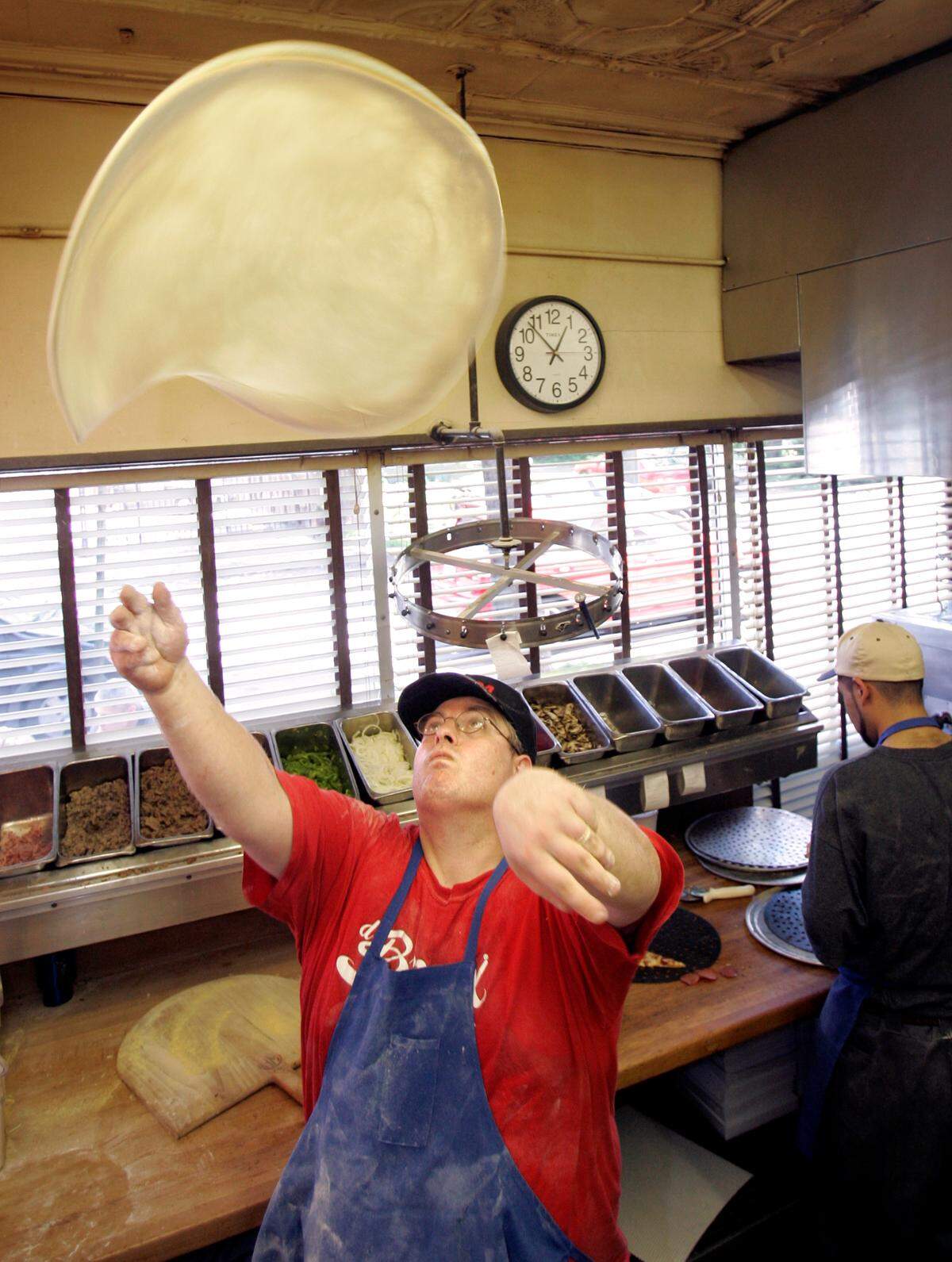 Pizza chef Mark Kincade tossed dough on May 20, 2005, at D’Bronx deli, 3904 Bell.