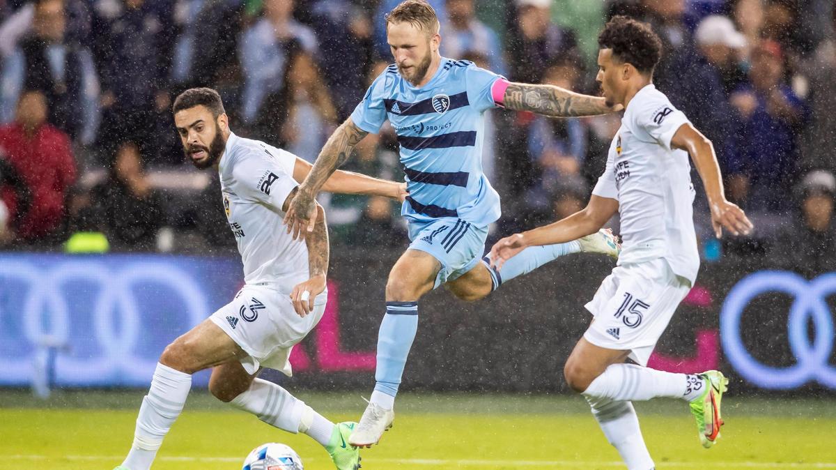 Sporting Kansas City forward Johnny Russell leaps between L.A. Galaxy players Wednesday night at Children’s Mercy Park in Kansas City, Kansas.