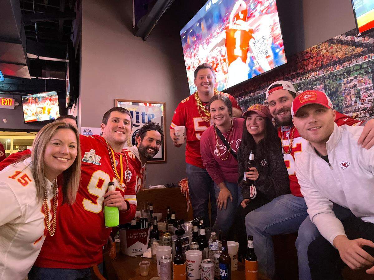 Clayton Harrison, far right, and his friends celebrated the Chiefs win at Maloney’s Sports Bar & Grill in Overland Park.