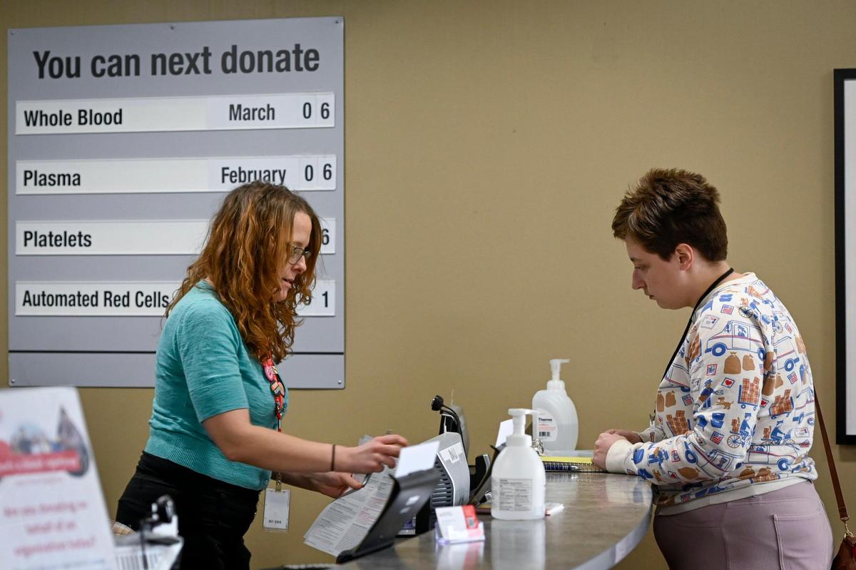 Kara Carpenter, left, takes registration information for Wallington.