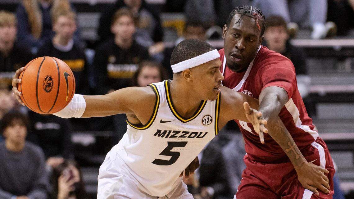 Missouri’s Jarron Coleman, left, keeps the ball away from Alabama’s Juwan Gary, right, during the first half of an NCAA college basketball game Saturday, Jan. 8, 2022, in Columbia, Mo. (AP Photo/L.G. Patterson)