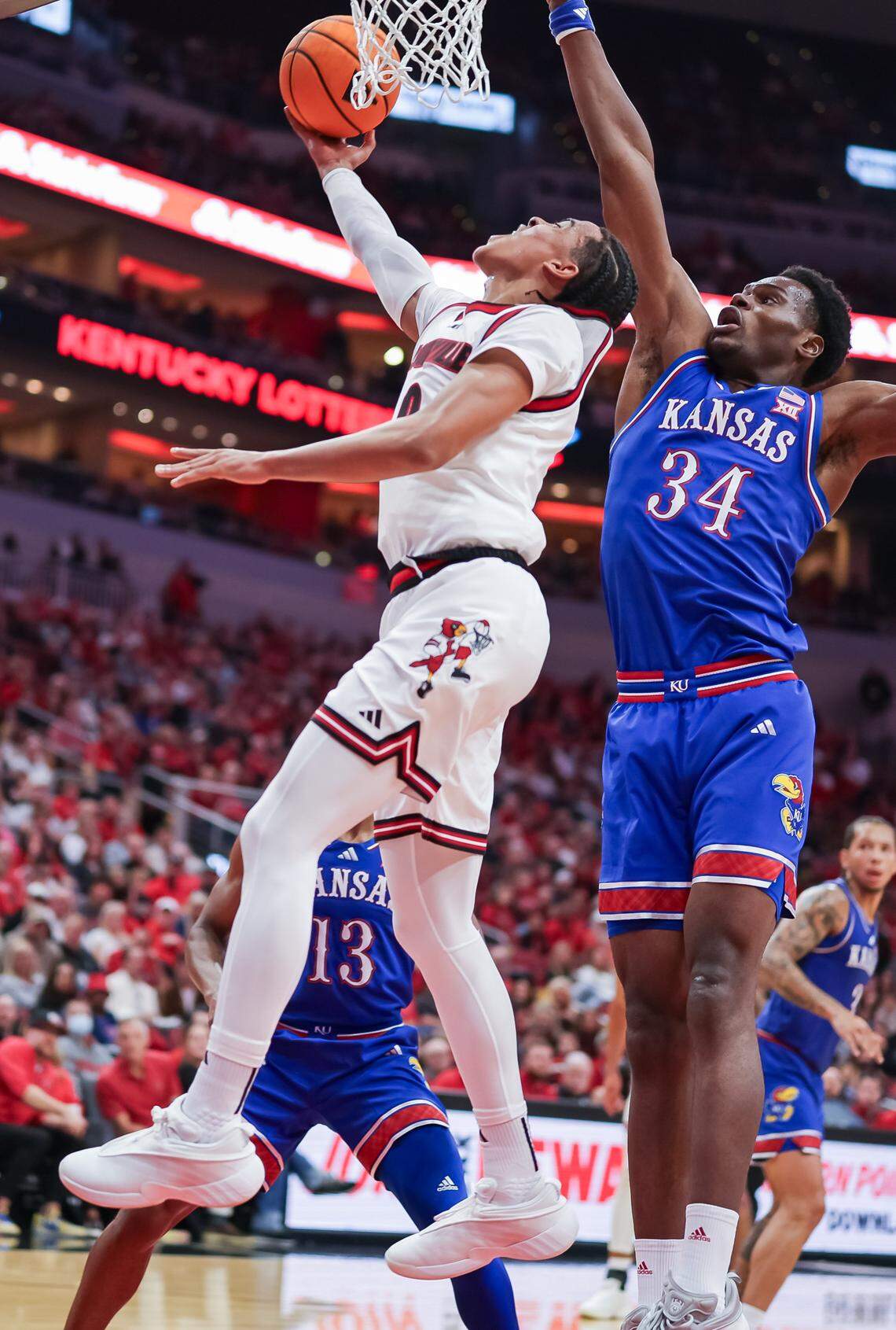 Mikel Brown Jr. of the Louisville Cardinals shoots over Kansas Jayhawks center Paul Mbiya during a men’s college basketball exhibition game at the KFC Yum! Center in Louisville, Kentucky on Friday, October 24, 2025.
