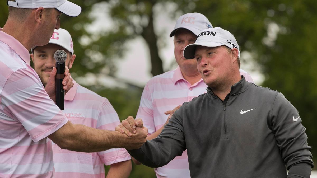Michael Gellerman (right) was congratulated by Drew VanMeeteren, executive director of the KC Golf Classic, after he won the event Sunday at Blue Hill Country Club.