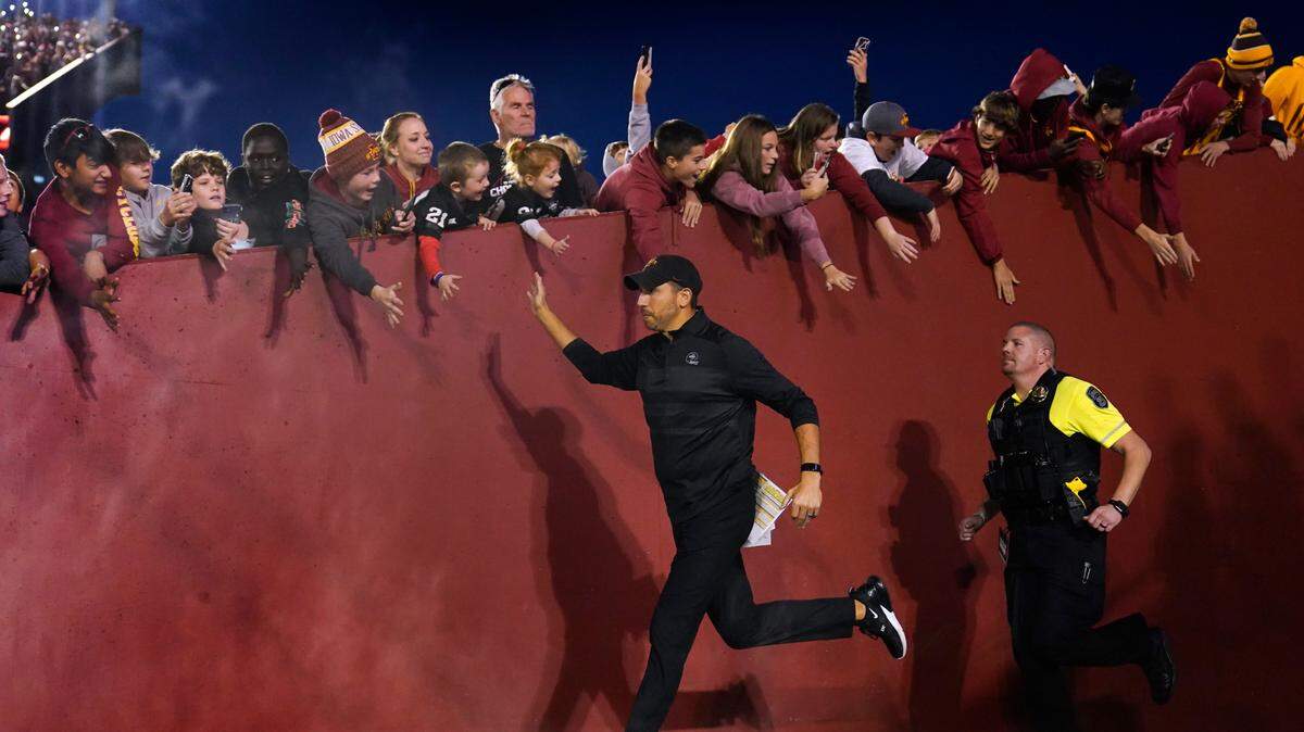 Iowa State head coach Matt Campbell greets fans as he runs to the field before a game against Texas last fall in Ames, Iowa. (AP Photo/Charlie Neibergall)
