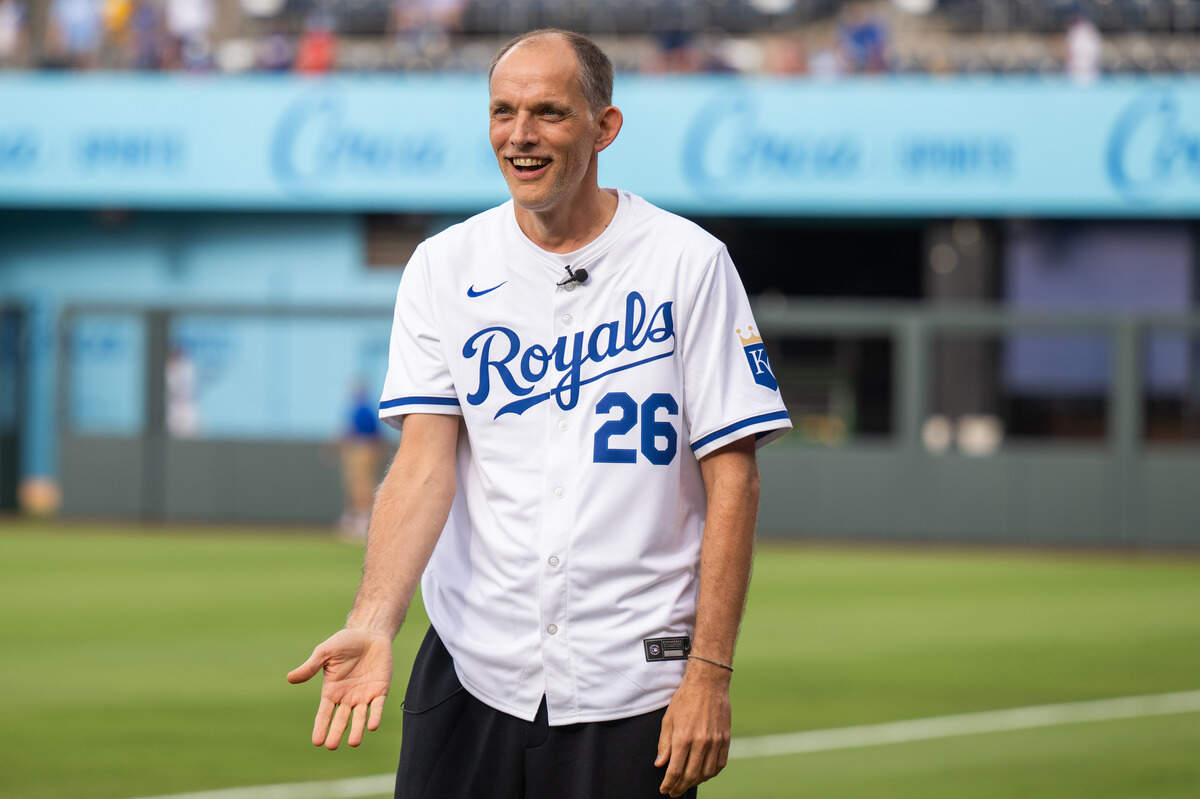 England national soccer team manager Thomas Tuchel wears a Royals jersey while visiting the team ahead of KC’s game against the St. Louis Cardinals at Kauffman Stadium in Kansas City on Thursday, June 18, 2026.