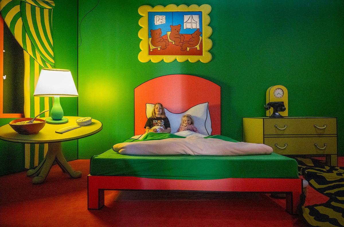 Osa Harper, 10, and her sister, Maggie Harper, 4, of Kansas City, tried out the bed in The Great Green Room, an exhibit based on the book “Goodnight Moon.”