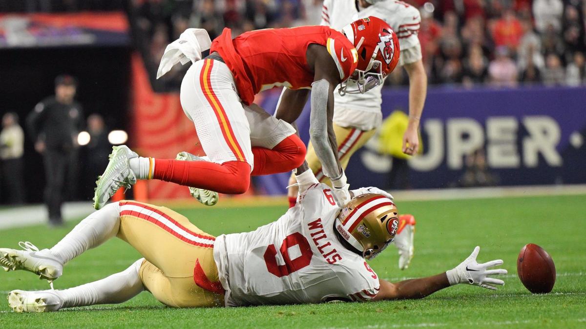 San Francisco 49ers tight end Brayden Willis (9) reaches for the ball while Kansas City Chiefs cornerback Joshua Williams (2) dives for it after the Chiefs blocked an extra-point attempt in the fourth quarter of Super Bowl LVIII, Sunday, Feb. 11, 2024, in Las Vegas.