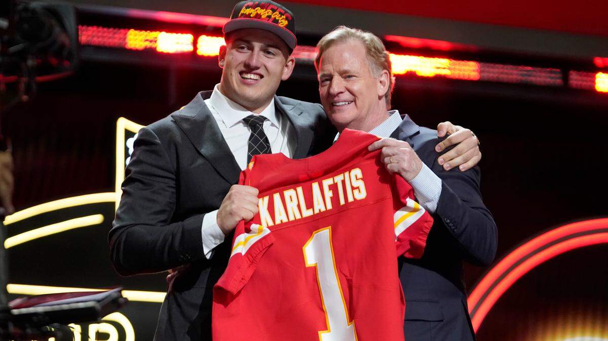 Purdue defensive end George Karlaftis, left, and Roger Goodell, Commissioner of the NFL, hold a team jersey after George Karlaftis was chosen by the Kansas City Chiefs with the 30th pick at the 2022 NFL Draft, Thursday, April 28, 2022, in Las Vegas. (AP Photo/Steve Luciano)