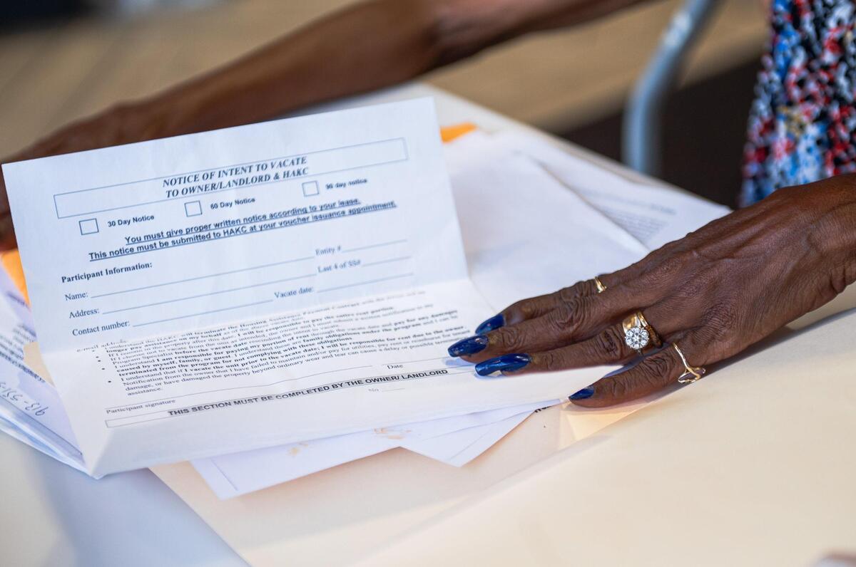 Vivian Jackson holds out a notice to vacate form at her home in Kansas City. Jackson is being forced to leave her home at the Emanuel Cleaver Senior Living Community by July 31.