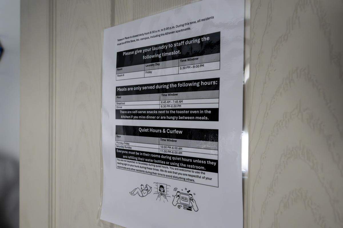 A posted sign outlines laundry times, meal hours and curfew rules for residents at Teresa's Place on Thursday, Sept. 11, 2025, in Kansas City. The shelter, formerly known as Pride Haven, recently underwent renovations and rebranding.
