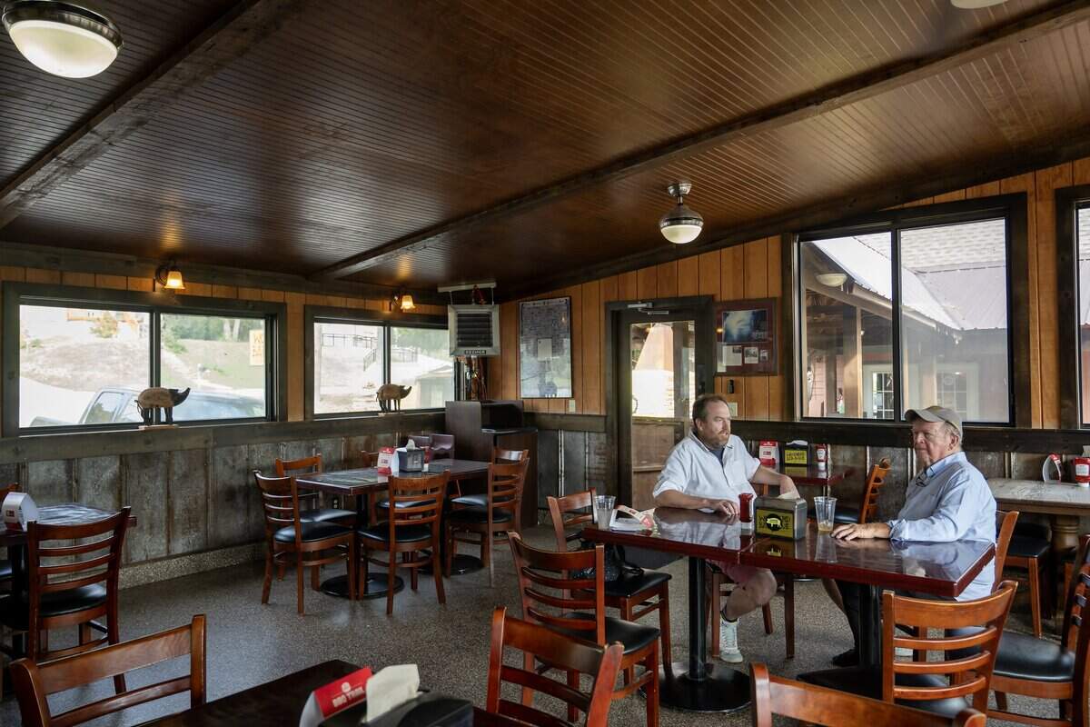 Frankie Schloegel, left, his father, Frank Schloegel III, talk in the dining room of their restaurant Woodyard Bar-B-Que, 3001 Merriam Lane, in Kansas City, Kansas, on Tuesday, October 14, 2025. The family-owned business is back under the family's management and is making some improvements to the restaurant. Scott will be the general manager.