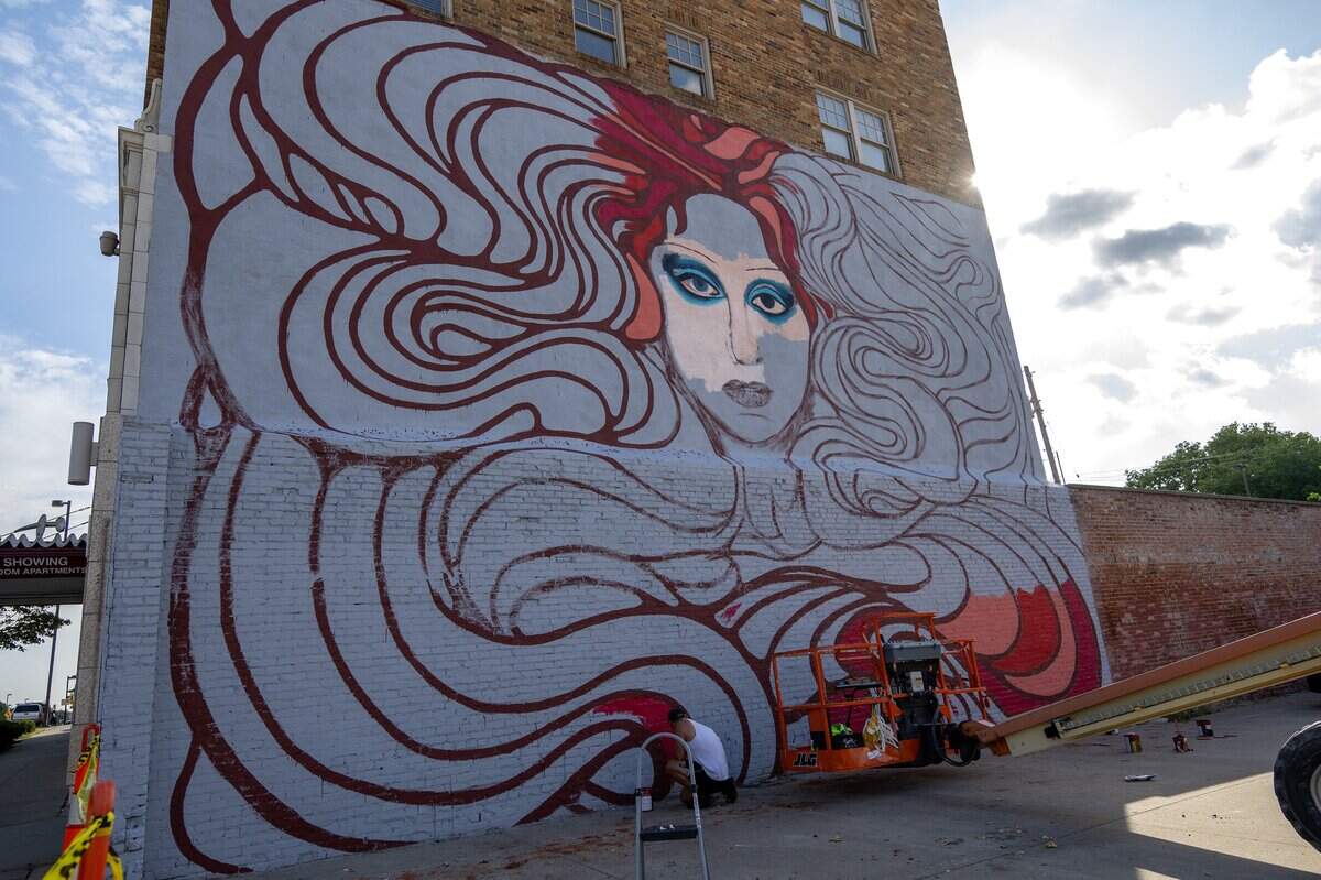 A mural of pop singer Chappell Roan takes shape along Broadway Boulevard on Wednesday, Sept. 24, 2025, in Kansas City. Artists Christine Riuzel and Jared Horman are collaborating on the project.