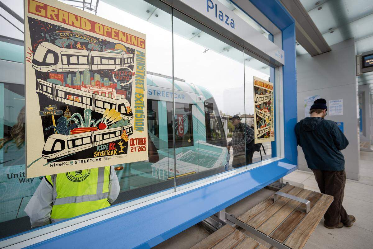 A grand opening poster was displayed on a new KC Streetcar stop at the Country Club Plaza during the launch of the three-and-a-half-mile extension on Friday, October 24, 2025.