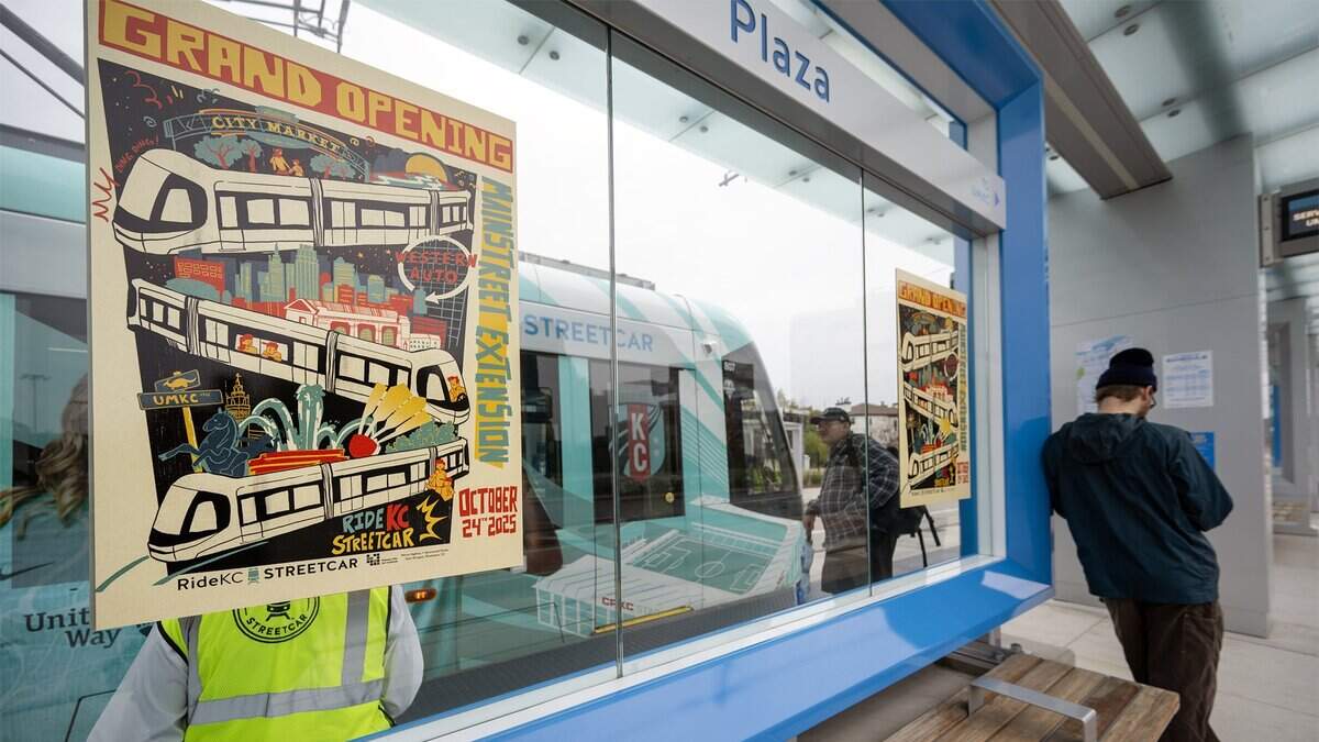 A grand opening poster was displayed on a new KC Streetcar stop at the Country Club Plaza during the launch of the three-and-a-half-mile extension on Friday, October 24, 2025.