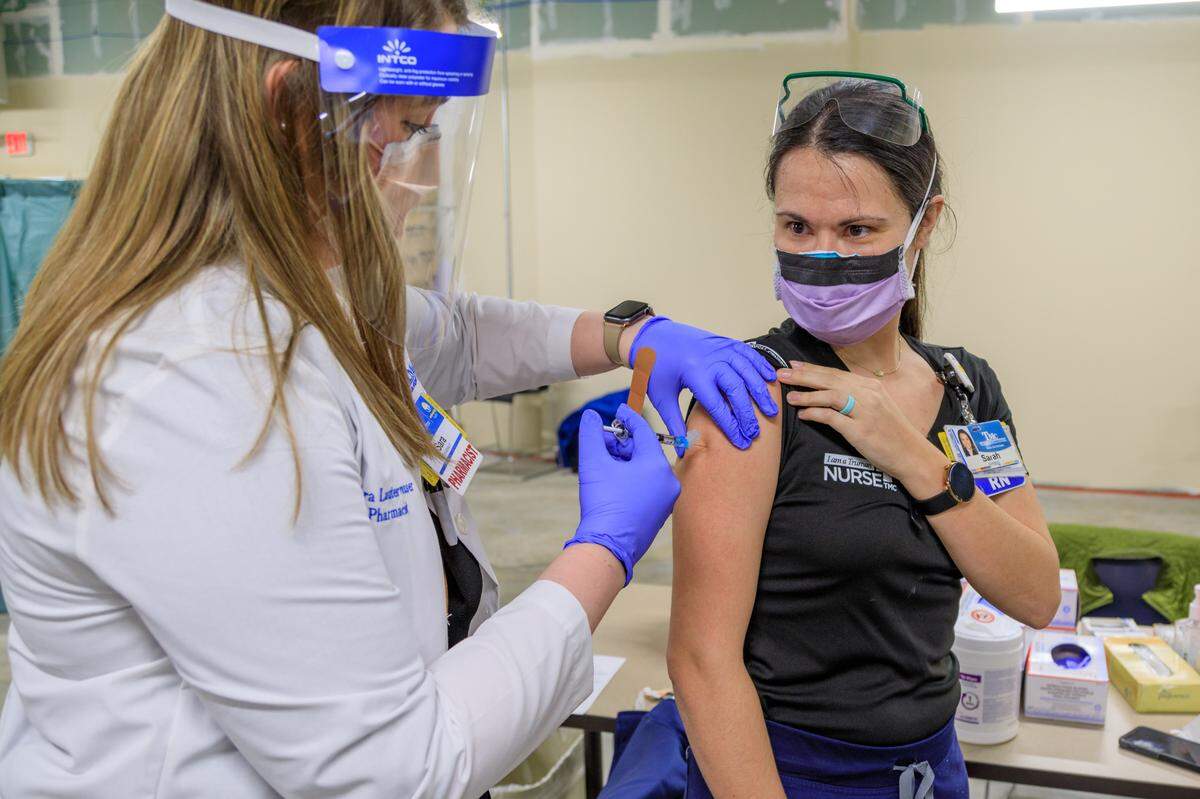 Sarah Kiehl, an ICU nurse at Truman Medical Centers, was the first worker there to receive the new coronavirus vaccine Monday.