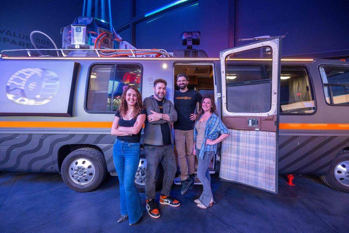 Part of the design team from Dimensional Innovations, inside their newest creation, Atlas 9, on Wednesday, Sep. 3, 2025, in Kansas City, Kansas. The narrative-driven immersive art experience featuring interactive games, videos, and AI-powered experiences, all housed inside a retro movie theater.