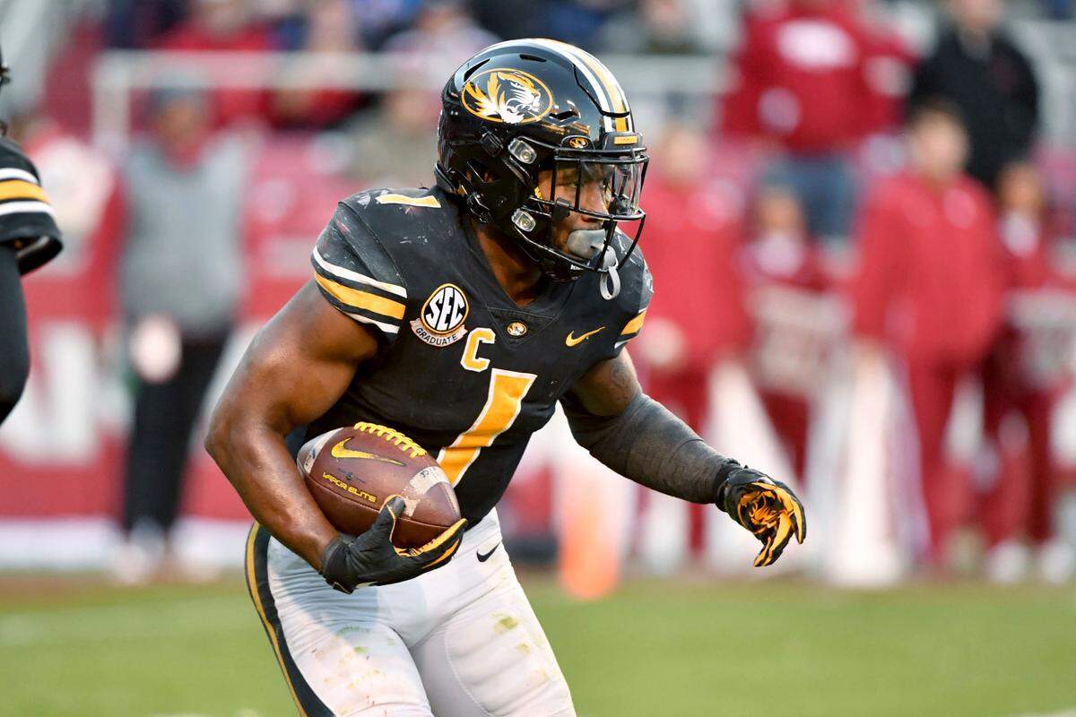 Missouri running back Tyler Badie (1) runs the ball against Arkansas during the second half of an NCAA college football game Friday, Nov. 26, 2021, in Fayetteville, Ark. (AP Photo/Michael Woods)