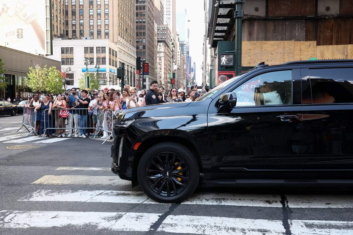 Onlookers gather as cars line up outside Madison Square Garden, the reported venue for the wedding celebrations of pop singer Taylor Swift and pro-athlete Travis Kelce, in New York City on July 3, 2026. Swift and Kelce's official wedding plans are tightly under wraps, but New York is bracing to host the celebrity marriage of the year this week at Madison Square Garden. The wedding will reportedly take place Friday with a star-studded guest list of around 1,000, including models Gigi Hadid and Cara Delevingne, singer Selena Gomez, and actress Zoe Kravitz -- all known to be close Swift pals -- and Kelce's Kansas City Chiefs teammates. (Photo by CHARLY TRIBALLEAU / AFP via Getty Images)