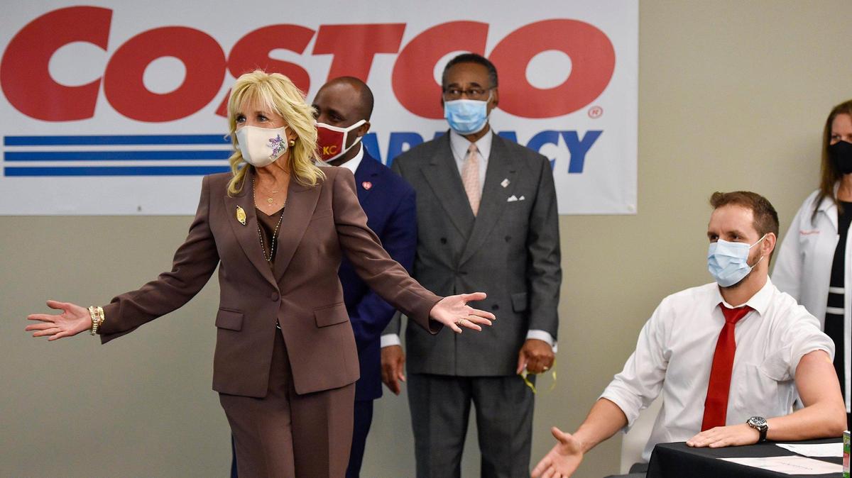First Lady Jill Biden gestures after speaking with a man, right, who just received a COVID-19 vaccine at a clinic on the Penn Valley campus of Metropolitan Community College in Kansas City, Missouri in May. Biden is set to return to the area on Tuesday to visit El Centro Academy in Kansas City, Kan.
