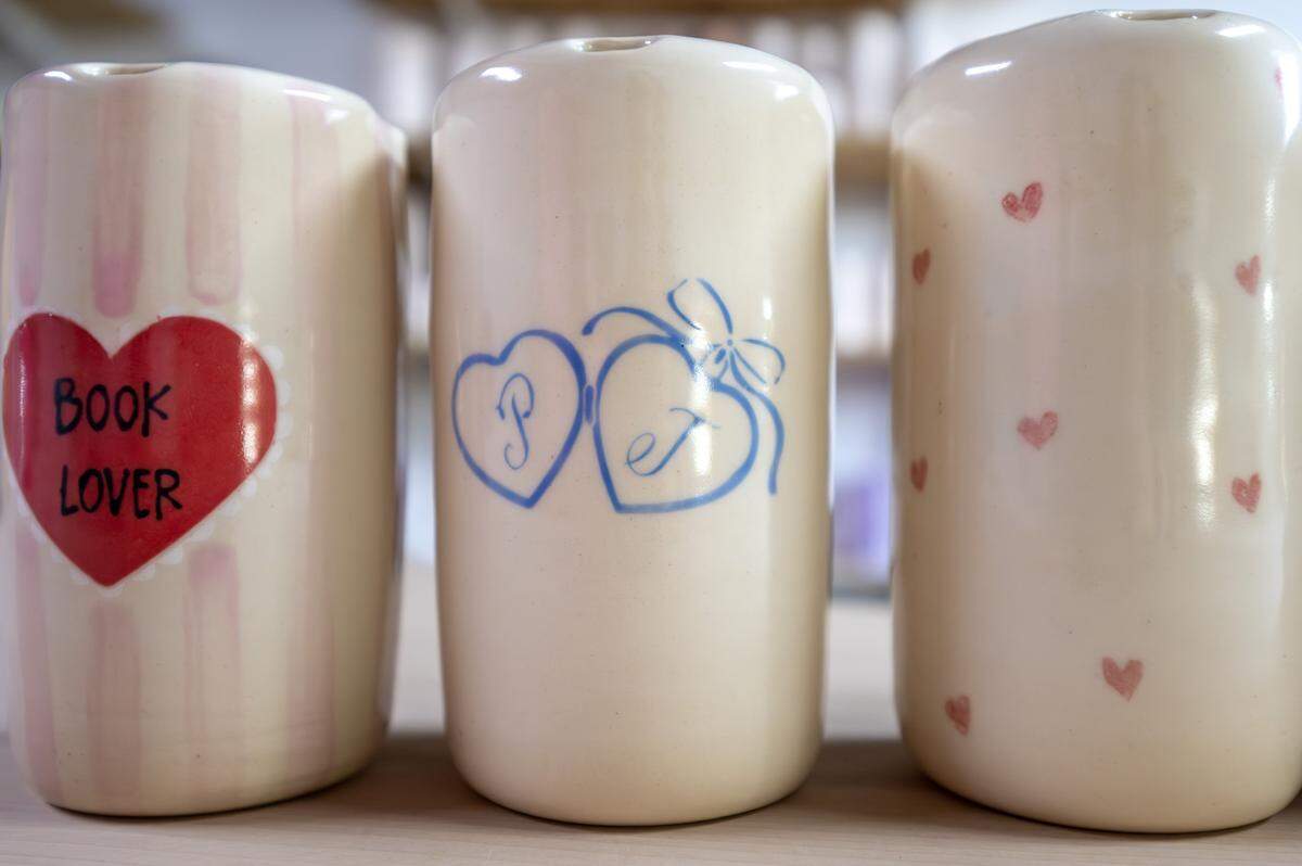 Valentine's Day-themed to-go ceramic cups made by ceramicist Priscilla Butler are displayed on a table at her studio, Lila's Clayground, on Thursday, Jan. 29, 2026, in Kansas City.
