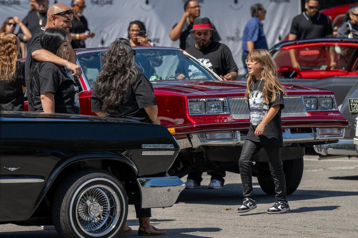 After the burial, family and friends gathered at a Kansas City park for a cookout with atteendees eating food, listening to music and daning in celebraton of the life of Efrain Gonzalez.