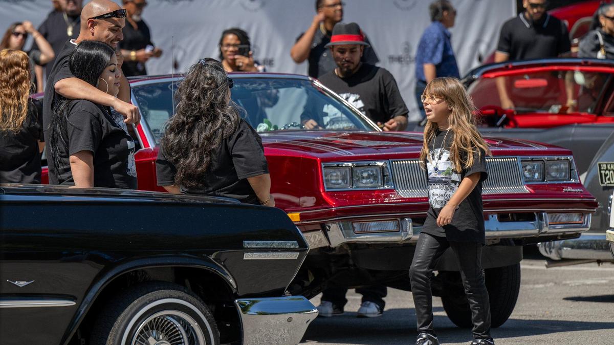 After the burial, family and friends gathered at a Kansas City park for a cookout with attendees, eating food, listening to music and dancing in celebration of the life of Efrain Gonzalez.