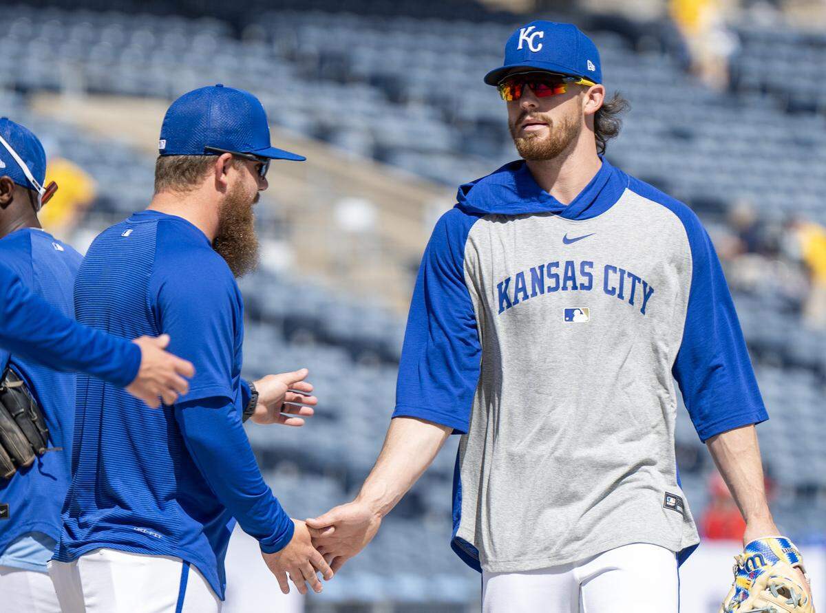 Kansas City Royals shortstop Bobby Witt Jr. (7) shakes hands with teammates during batting practice before the home opener against the Minnesota Twins at Kauffman Stadium on Monday, March 30, 2026, in Kansas City.