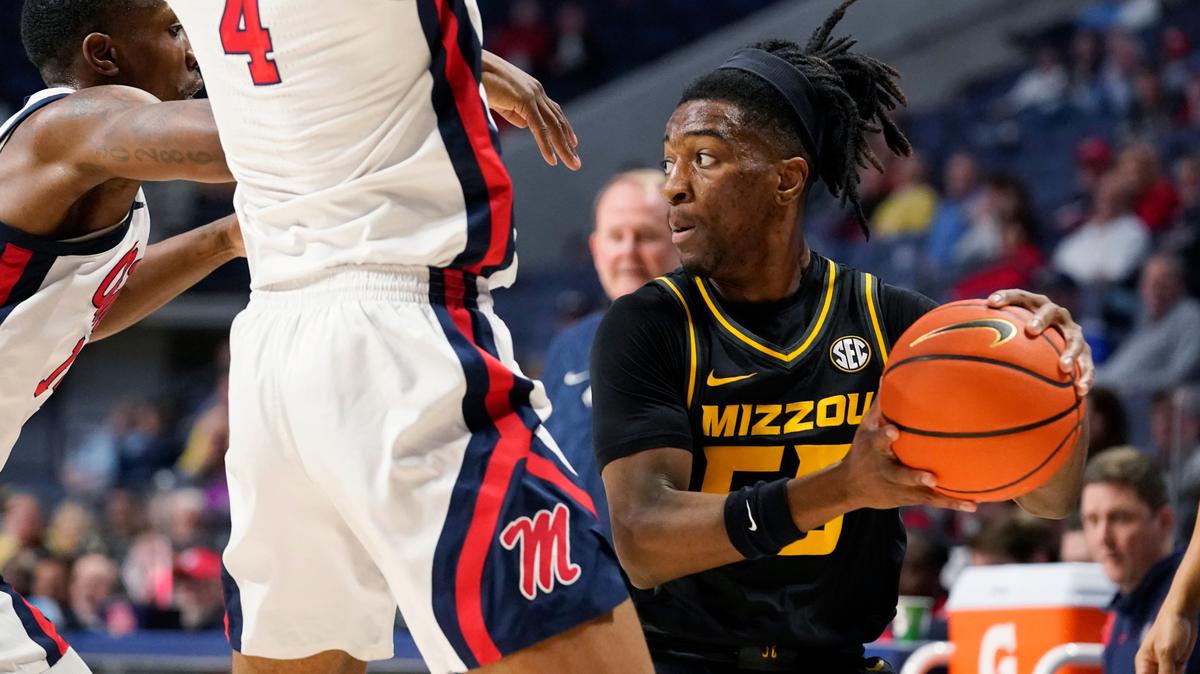 Missouri guard Sean East II (55) is pressured by Mississippi forward Jaemyn Brakefield (4) during the first half of an NCAA college basketball game in Oxford, Miss., Tuesday, Jan. 24, 2023.