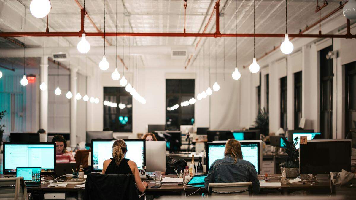 Employees work at an office in this stock image. .