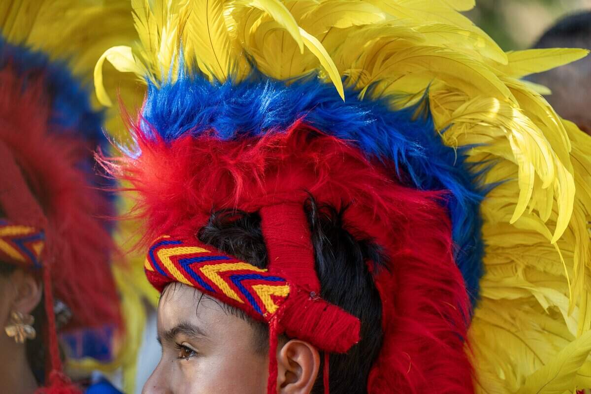 A Colombia supporter wears a traditional feathered headdress during a Colombia banderazo at Mill Creek Park on Thursday, July 2, 2026, in Kansas City.