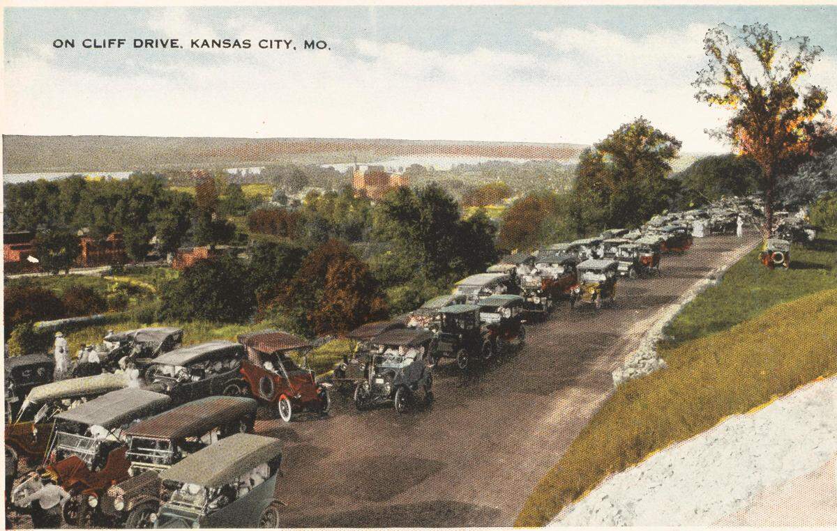 Postcard showing a line of vehicles on Cliff Drive, ca. 1915. The route was westbound only for motorists during this period.