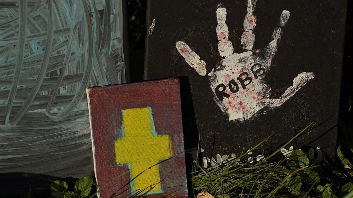 Various pieces of art help make up a memorial to honor the school shooting victims at Robb Elementary, Monday, July 11, 2022, in Uvalde, Texas.   Students who survived the May 24 shooting at an elementary school in Uvalde, Texas are spending the summer grappling with post-traumatic stress disorder. Meanwhile, parents find themselves unable to help them, worried the tragedy at Robb Elementary struck a largely Hispanic town as Latinos continue to face disparities to access mental health care.  (AP Photo/Eric Gay)